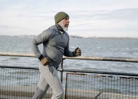 serious black man running on embankment
