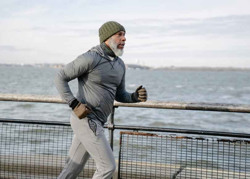serious black man running on embankment